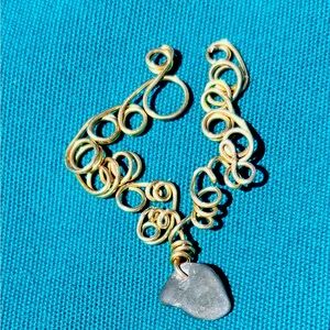 Hand wire wrapped Finger Lakes “lucky” stone pendant.